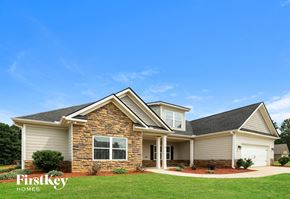 Gainesville house for rent - A house with a stone facade and a large front yard.