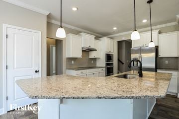 Gainesville house for rent - A kitchen with granite countertops and white cabinets.