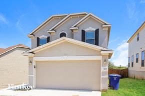 San Antonio house for rent - A two-story house with a garage and a blue trash bin in front.