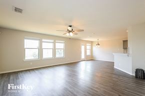 San Antonio house for rent - A spacious room with a ceiling fan and wooden flooring.