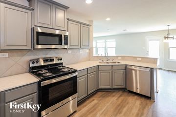 San Antonio house for rent - A kitchen with a stove top oven and microwave.