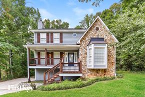 Hiram house for rent - a small house with a deck on a lawn and trees