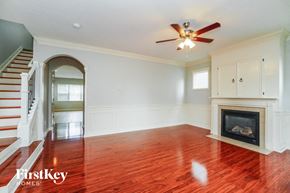 Dublin house for rent - A spacious room with a fireplace and a staircase.