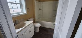 Bolton apartment for rent - A bathroom with a toilet, sink, and bathtub.