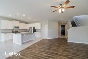 Riverview house for rent - A spacious kitchen with a wood floor and a ceiling fan.
