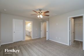 Riverview house for rent - A spacious room with a ceiling fan and a carpeted floor.