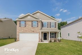 Charlotte house for rent - a brick house with a white garage door