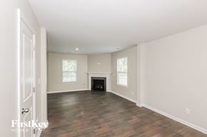 Charlotte house for rent - a living room with a fireplace and a wooden floor