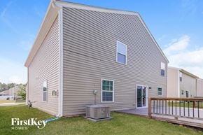 Charlotte house for rent - the exterior of a house with a deck and a grill