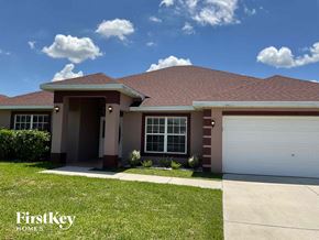 Lehigh Acres house for rent - A house with a brown roof and a white garage door.