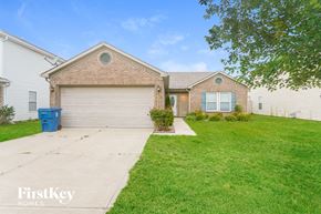 Camby house for rent - a home with a white garage door and a green lawn