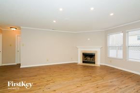Camby house for rent - a living room with a fireplace and a wooden floor
