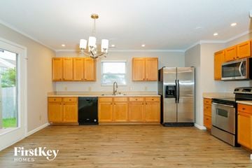 Camby house for rent - a kitchen with wooden cabinets and stainless steel appliances