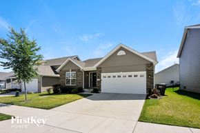 Lake St Louis house for rent - a house with a white garage door in front of a lawn