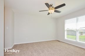 Lake St Louis house for rent - a bedroom with a ceiling fan and a window