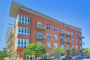 Austin apartment for rent - A red building with a balcony on the second floor.
