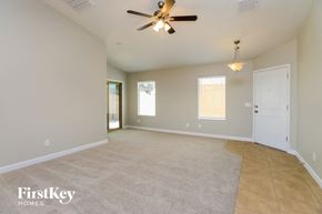 Florence house for rent - an empty living room with a ceiling fan and a white door