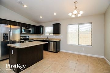 Florence house for rent - a kitchen with an island and a stainless steel refrigerator
