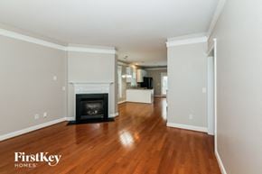 Charlotte house for rent - A living room with a fireplace and wooden floors.