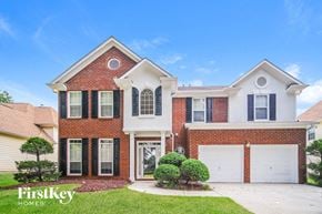 Atlanta house for rent - a red brick house with a white garage door