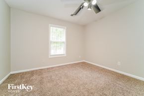 Atlanta house for rent - the spacious bedroom with carpeted flooring and a ceiling fan