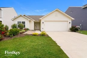 Indianapolis house for rent - a white house with a lawn and a driveway