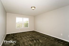 Indianapolis house for rent - the bedroom of a home with carpet and a window