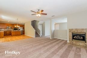 Jacksonville house for rent - A spacious living room with a fireplace and a staircase.