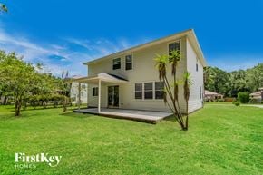 Jacksonville house for rent - A house with a lawn and trees in front of it.