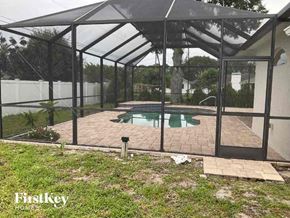 Englewood house for rent - a patio with a pool in a glass house
