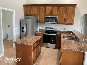 Englewood house for rent - a kitchen with stainless steel appliances and granite counter tops