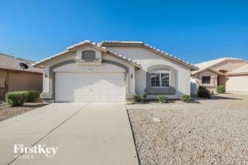 Glendale house for rent - a white house with a white garage door and a gravel driveway