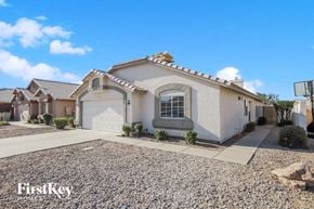 Glendale house for rent - a white house with a white garage door and a gravel driveway