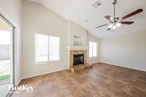 Glendale house for rent - a living room with a fireplace and a ceiling fan