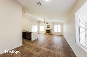 Glendale house for rent - an empty living room with a kitchen and a fireplace