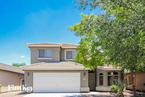 Laveen house for rent - a house with a white garage door and a tree