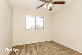 Laveen house for rent - a bedroom with a ceiling fan and a window