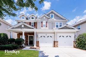 Monroe house for rent - a white house with two white garage doors