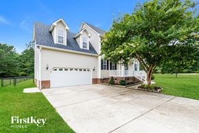 Raleigh house for rent - a white house with a driveway and a tree