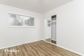 Kirkwood house for rent - a bedroom with a closet and a window and wood flooring