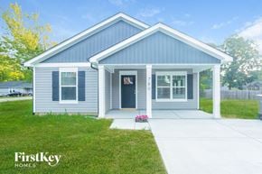 Kannapolis house for rent - the exterior of a blue house with a sidewalk and grass