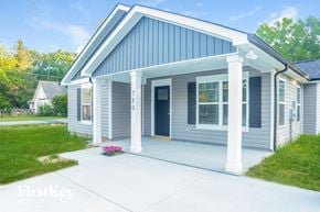 Kannapolis house for rent - the front of a blue house with a concrete driveway