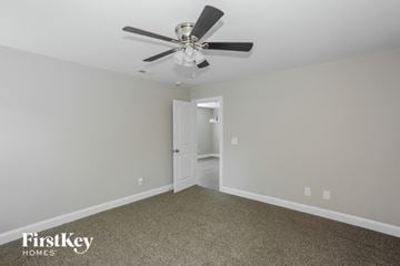Kannapolis house for rent - a living room with a ceiling fan and carpet