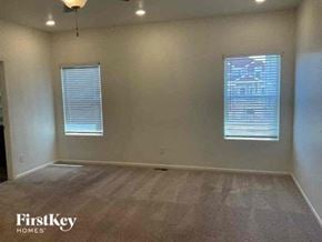 Colorado Springs house for rent - an empty living room with two windows in it