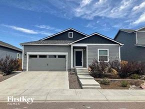Colorado Springs house for rent - a gray house with a driveway and a garage door
