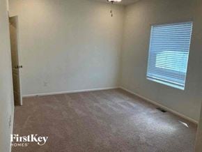 Colorado Springs house for rent - an empty room with a window and a carpet