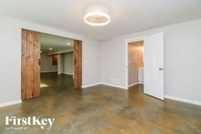 Moscow Mills house for rent - A room with a wooden door and a white door.