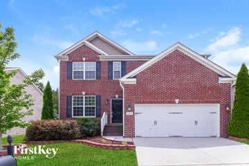 Clemmons house for rent - a red brick house with a white garage door