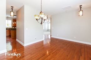 Clemmons house for rent - the living room and dining room with wood flooring and two chandeliers