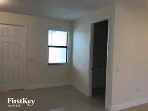 Lehigh Acres house for rent - an empty room with a window and a door